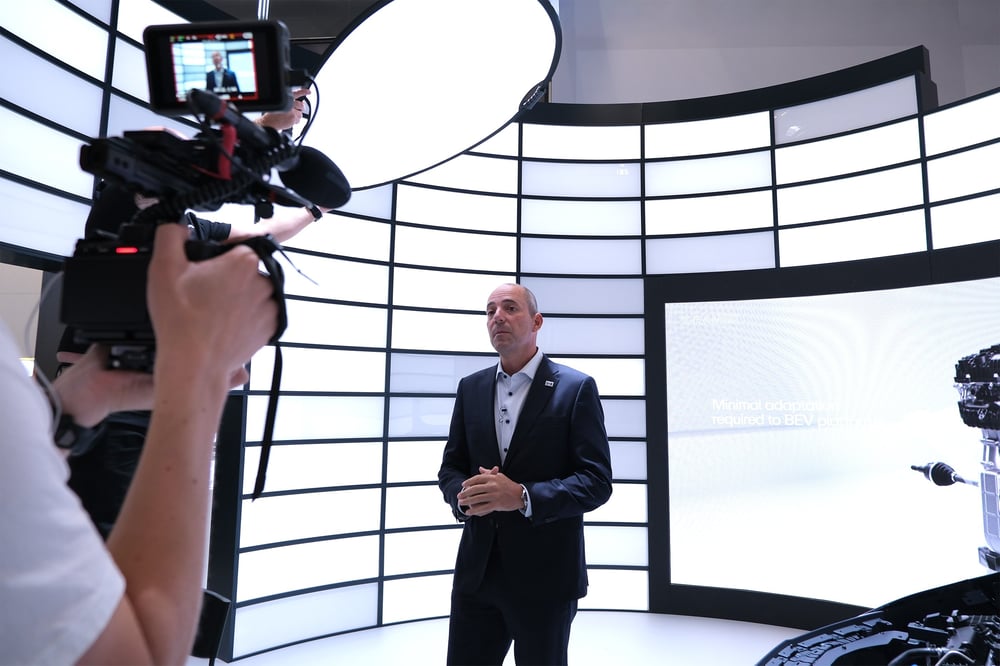 Horse Powertrain CEO Matias Giannini talks to a camera at an event booth