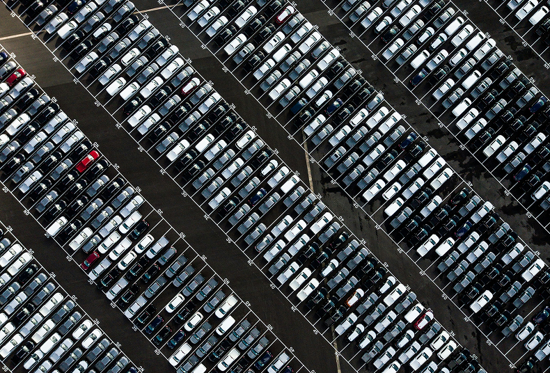 a parking lot from above with hundreds of cars 