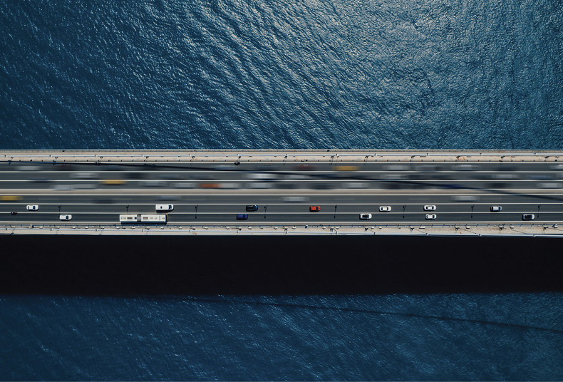 from above, Cars in a movement at a bridge over ocean